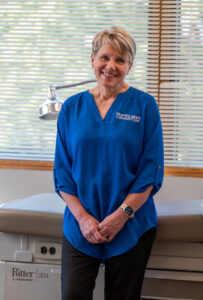 Woman in blud shirt smiling at camera