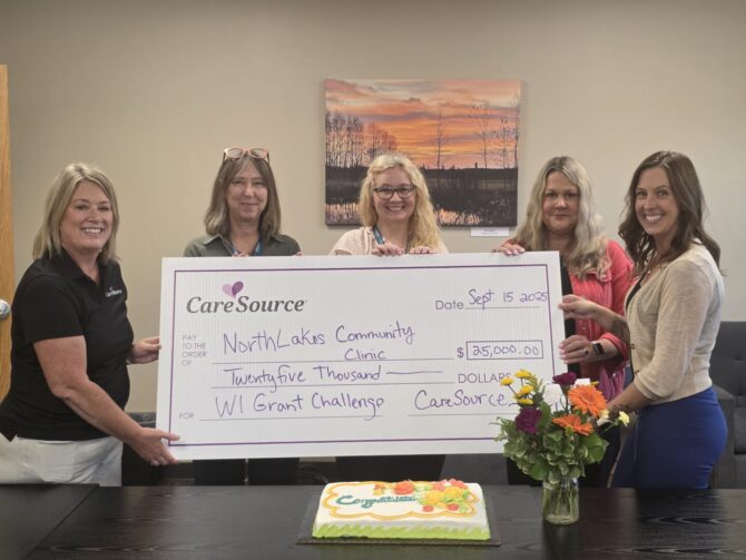 group of women holding large check