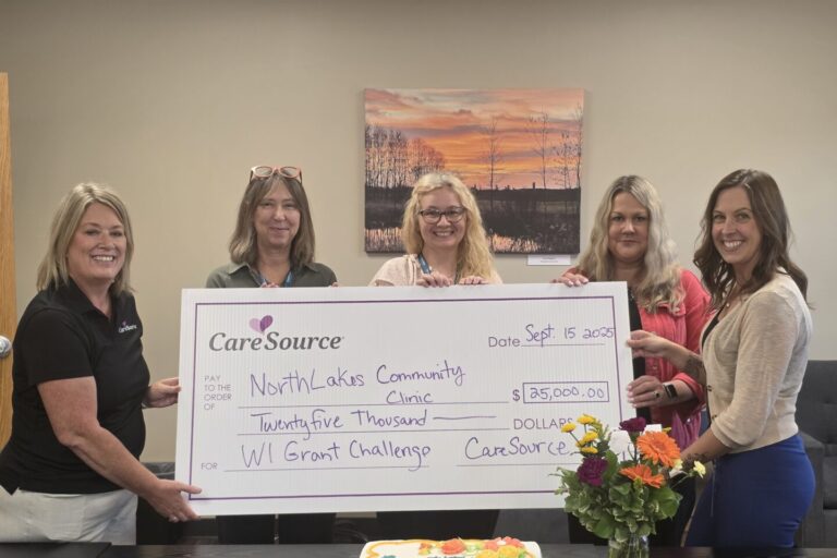 group of women holding large check