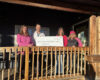 group holding check on front porch