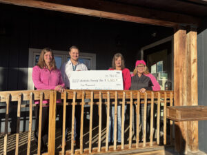 group holding check on front porch