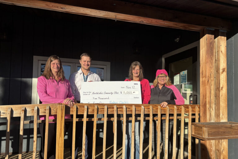 NorthLakes-Fishin-Chicks-IR25-2 group holding check on front porch