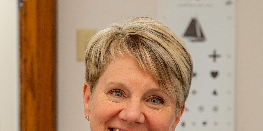 Tina-Opelt-NorthLakes-headshot-1125 woman headshot with short haire in blue shirt