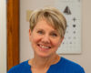 woman headshot with short haire in blue shirt