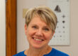 woman headshot with short haire in blue shirt
