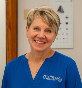woman headshot with short haire in blue shirt