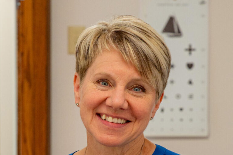 Tina-Opelt-NorthLakes-headshot-1125 woman headshot with short haire in blue shirt